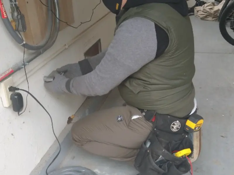 Electrician performing outlet wiring in a Unadilla garage